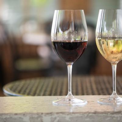 A glass of red and a glass of white wine on display.