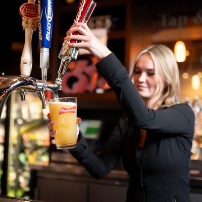 Bartender pouring tap beer.