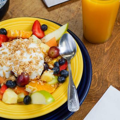 fruit bowl with granola and yogurt.