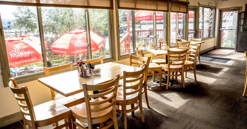 Interior, dining tables and chairs by a window side