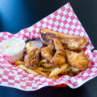 Chicken tenders on a bed of fries, served with a toast , coleslaw and a dip.