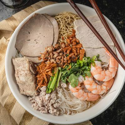 Noodle bowl with pork, shrimp, and herbs.