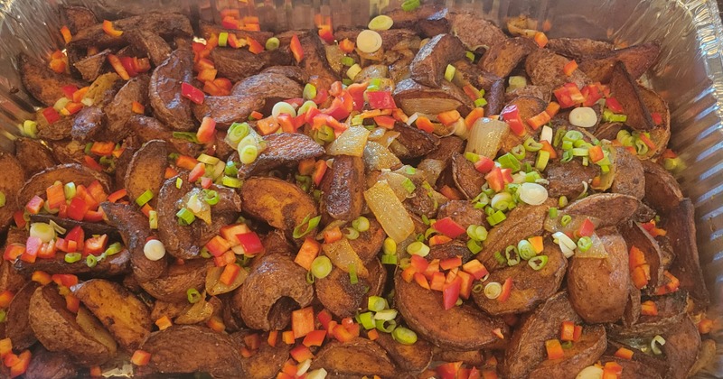 Roasted potato wedges with green onions and red peppers