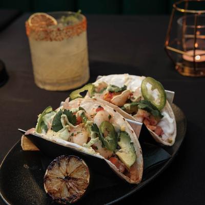Shrimp tacos and a cocktail drink.