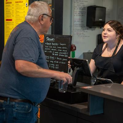 A guest talking to a member of the staff.