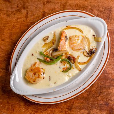 Melted cheese sauce seasoned with chorizo and spices, topped with shrimps.