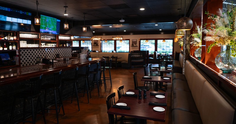 Interior seating area with chairs, tables, booths and a bar
