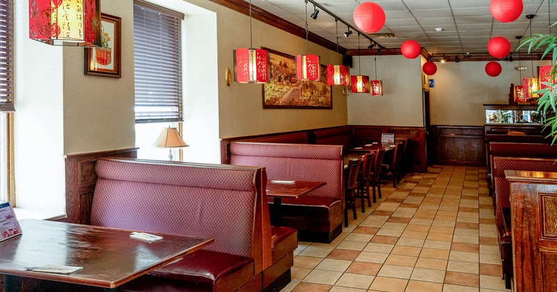 Interior of a restaurant with red cushioned booths