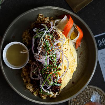 Scrambled eggs with a house-made sausage, garlic fried rice, and green onion slaw.