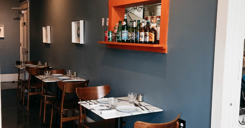 Interior, tables, chairs, bottles on a shelf, doors