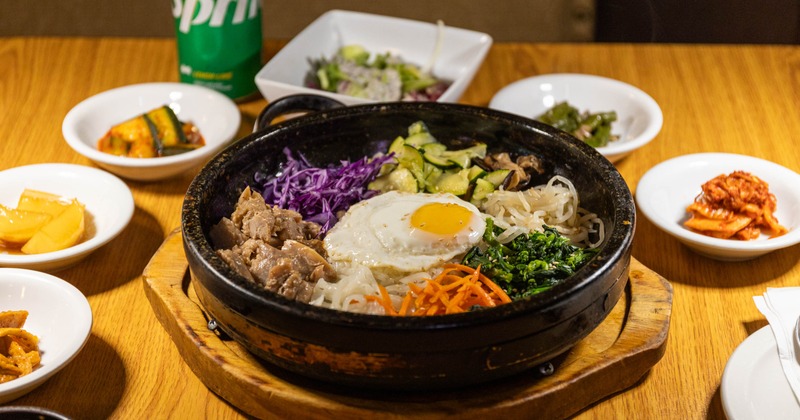 Danji Bibimbap topped with fried egg and served with various sides