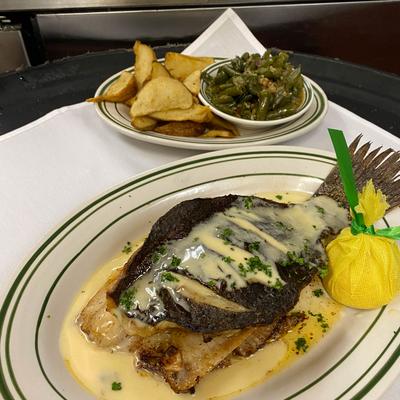 Stuffed whole flounder topped with beurre blanc sauce...served with new potatoes & green beans.