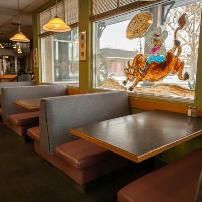 Row of restaurant booths beside large windows.