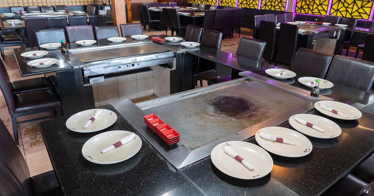 Japanese hibachi style interior dining area with large teppanyaki grill tables