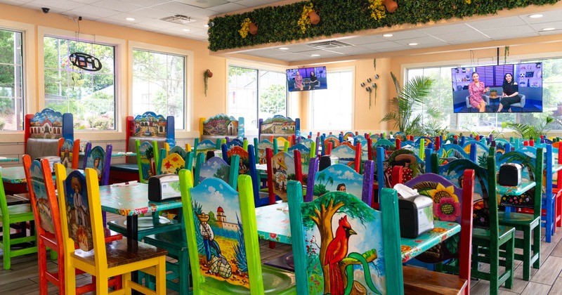 Interior, dining area, tables with colorful chairs, painted with various Mexican motifs