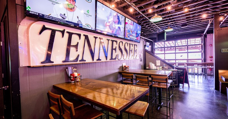 Interior, bar tables and stools, TV sets on the wall