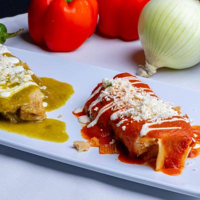 Tamales smothered in red and green sauces.