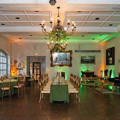 Reception set up with a mix of seating optopns and chandeliers hangimg from the cieling.