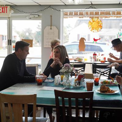 Interior, guests enjoying their meals with a large windows backdrop.