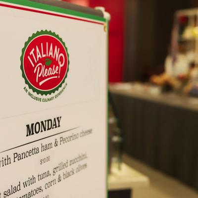 Restaurant's menu board with interior in the background.