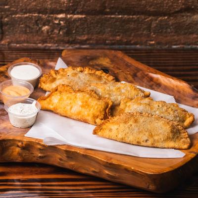 Empanadas served with sauces for dipping.