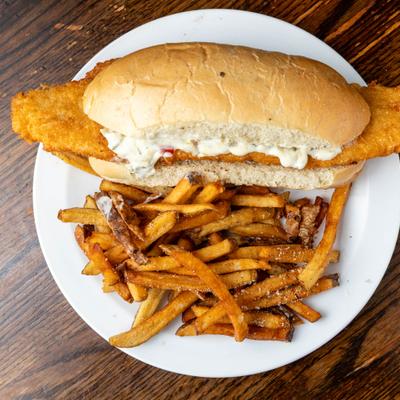 Fried fish sandwich with side fries.