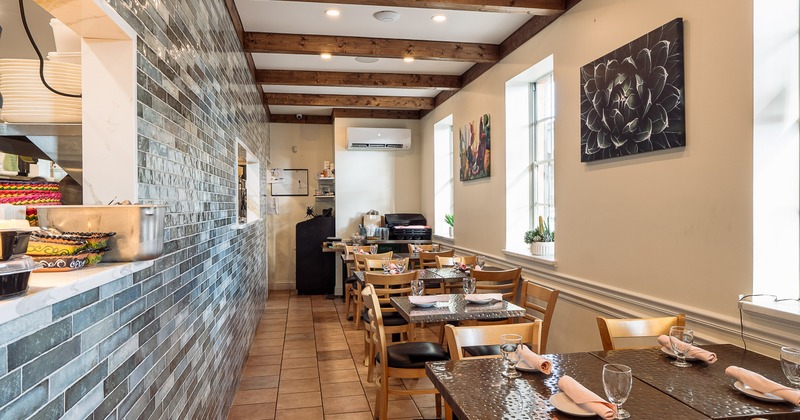 Interior of cozy dining area with set dining tables