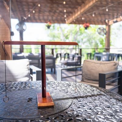 Outdoor seating area, A metal table with a Hook and Ring game.