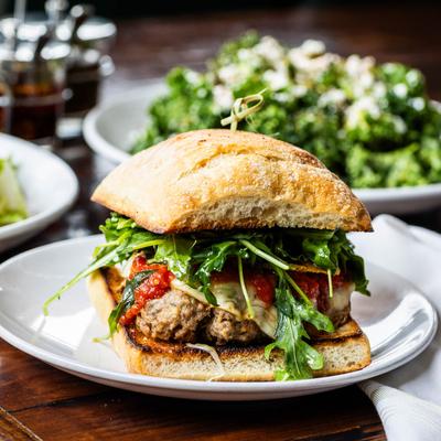 Meatball Sandwich plate on a table with food.