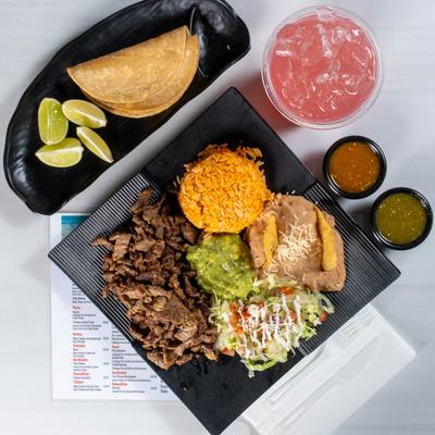 Grilled beef, salad, rice, and refried beans.
