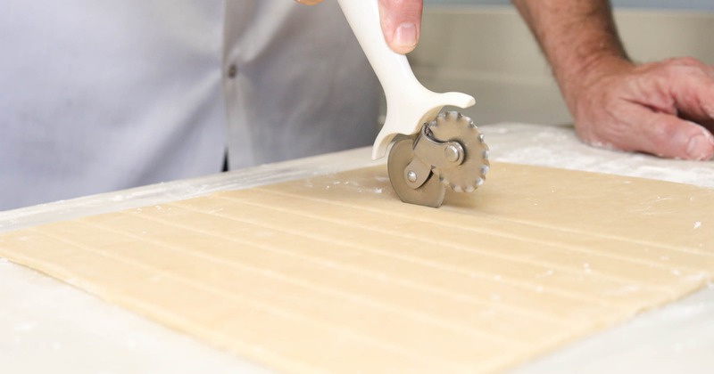 Cutting lattice pie dough strips using a pastry wheel cutter
