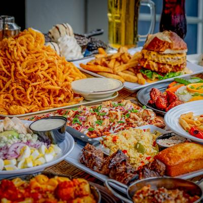 Assortment of food dishes and drinks displayed on a table.
