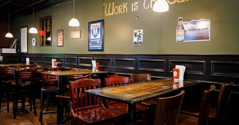 Tables and chairs beside a wall