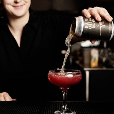 Bartender pouring a cocktail.