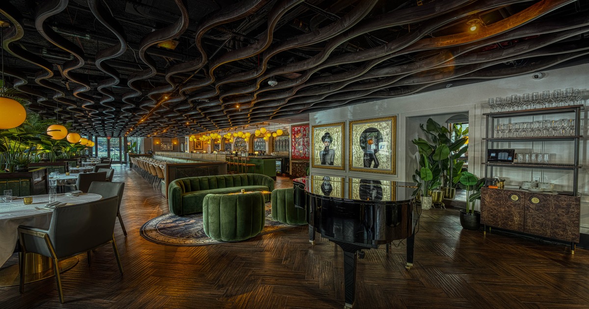 Interior, lounge and dining area, stage piano, sofa with armchairs, round table for two