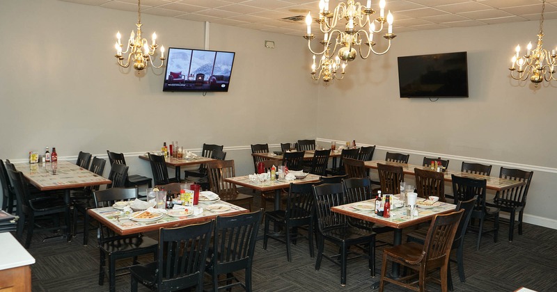 Interior, chandeliers, set tables, chairs, wall TV