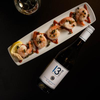 Shrimp with capers and a bottle of white wine.