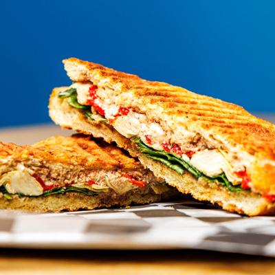 Salty Sea Panini served on pressed bread, close-up.