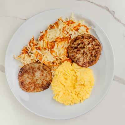 Scrambled eggs served with  two sausage patties and shredded hash browns.