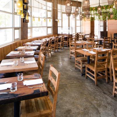 Tables and chairs by the windows.