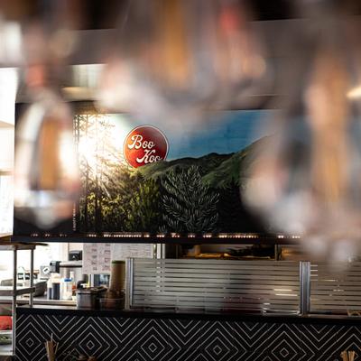 View of the counter area with large mural with signage behind it.