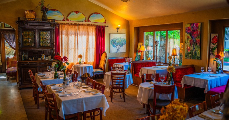 Interior, dining tables and chairs ready for guests, booth area in the back