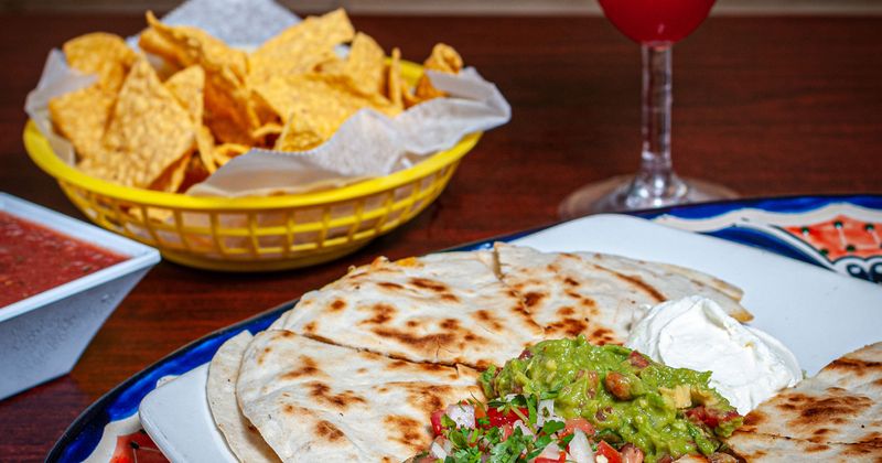Quesadillas plate, salsa, tortilla chips and Strawberry Daiquiri