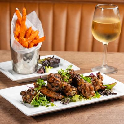 Caribbean Jerk Chicken Wings, sweet potato fries, and white wine.
