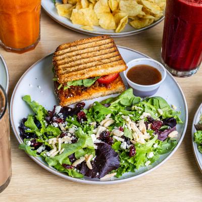 Mariposa salad with cranberries, goat cheese and candied almonds, served with BLT sandwich.