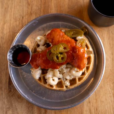 Waffle topped with spicy chicken, mac and cheese and jalapenos.