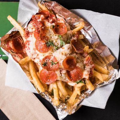 Fries topped with melted cheese and pepperoni.