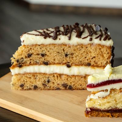 Slice of cake served on a wooden board.