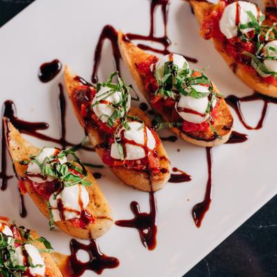 Vegetarian Bruschetta with focaccia, mozzarella, tomatoes, basil, and balsamic.