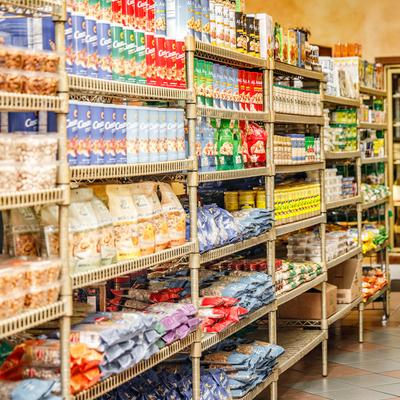 Assorted food products on shelves in a grocery store aisle.